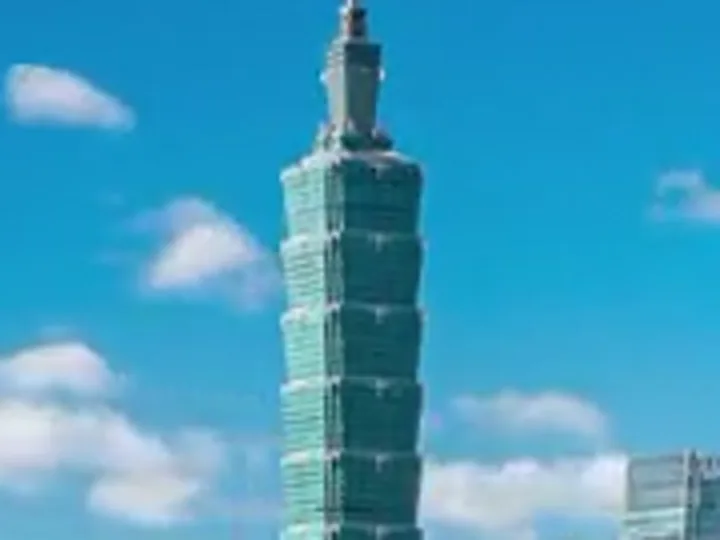 Crop of an 854×480 city frame, a tower against a blue sky, enlarged with bicubic scaling